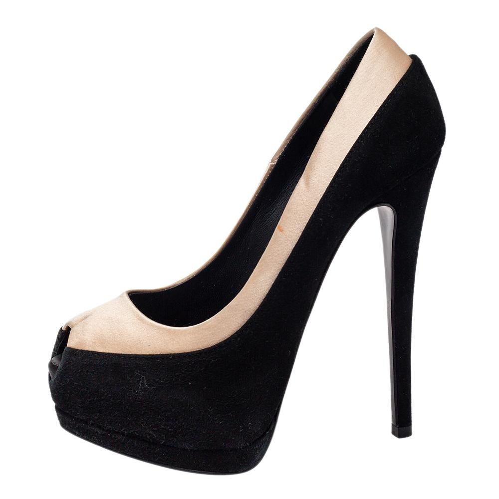Displaying a beautiful design through a contrast of black suede and beige satin, Giuseppe Zanotti manages to elevate the simple pumps into a statement-making pair. The pumps feature peep toes, platforms, and 13.5 cm heels.