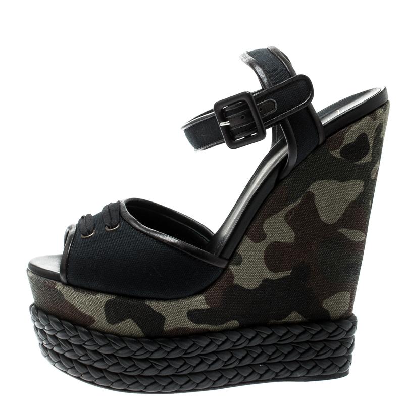 These Giuseppe Zanotti sandals exude charm with the braid details and camouflage wedge heels. They feature open toes and buckle ankle straps. These gorgeous sandals are comfortable to be worn all day long.

