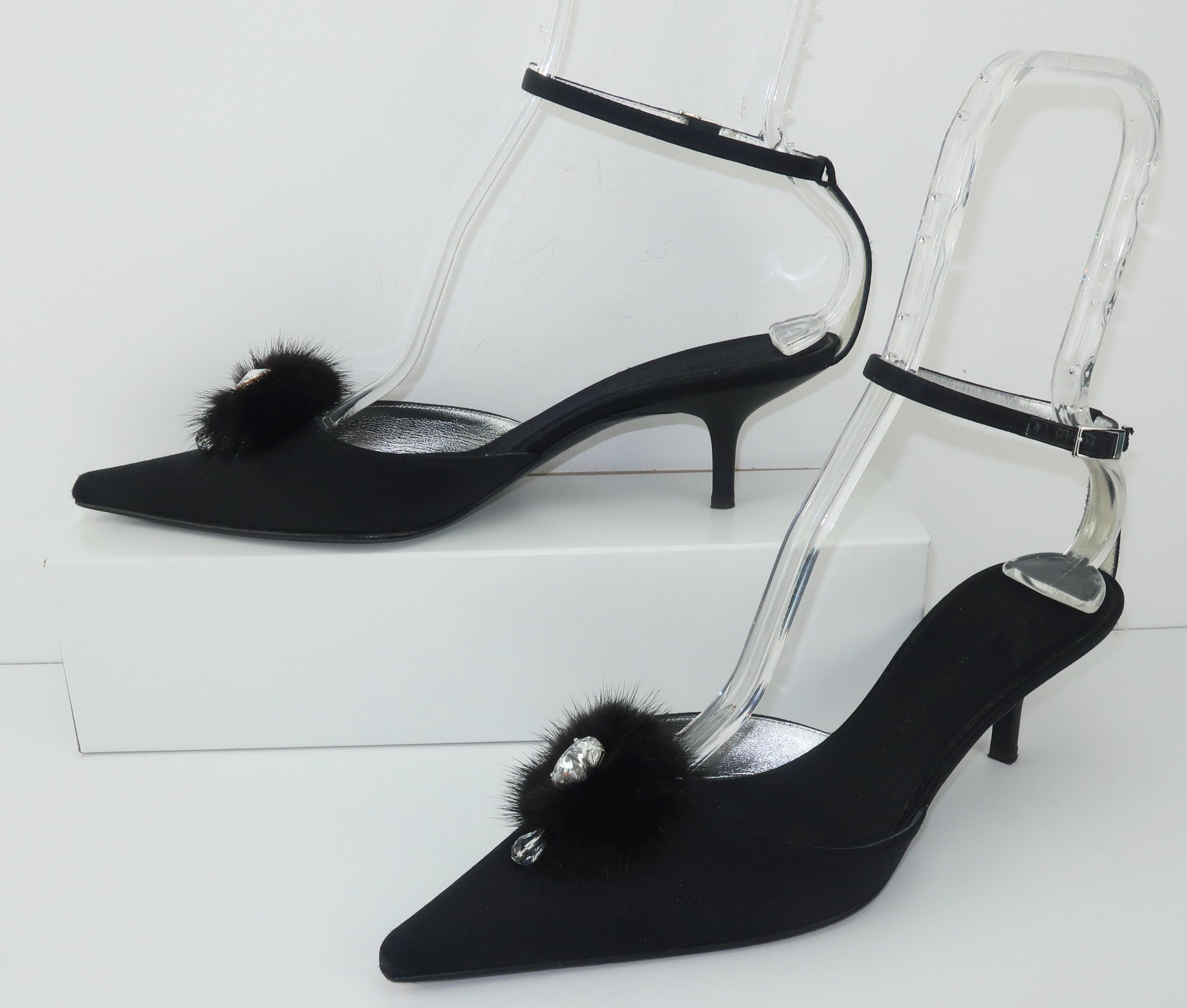 Giuseppe Zanotti creates an elegant black satin evening shoe embellished with a fur pom pom and a crystal rhinestone drop.  The kitten heel has an unusual rubber finish giving a little edge to the look and along with the buckled ankle strap allows