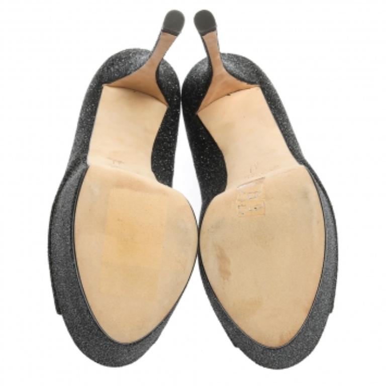 These gorgeous pumps from Giuseppe Zanotti are set on solid platforms and 16 cm high heels. They have been crafted from black glittered suede and styled with open-toes. They are complete with comfortable leather-lined insoles and will never fail to