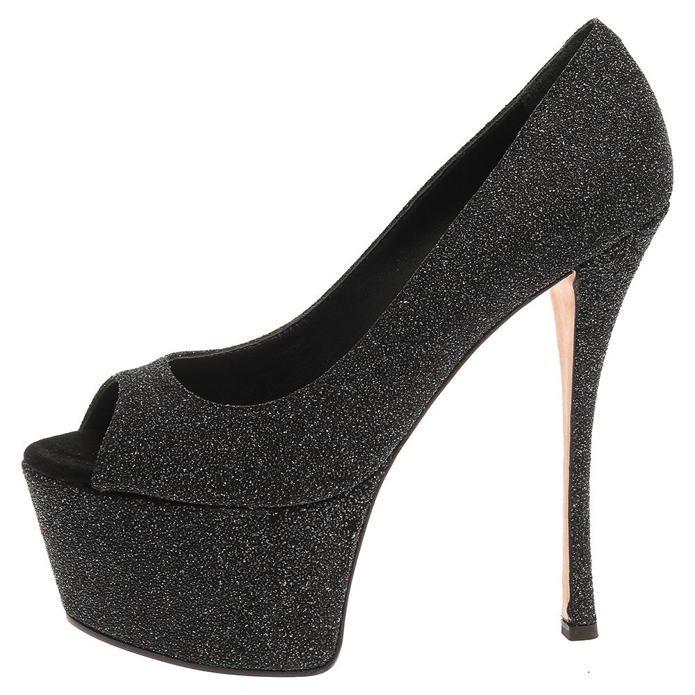 These gorgeous pumps from Giuseppe Zanotti are set on solid platforms and 16 cm high heels. They have been crafted from black glittered suede and styled with open-toes. They are complete with comfortable leather-lined insoles and will never fail to
