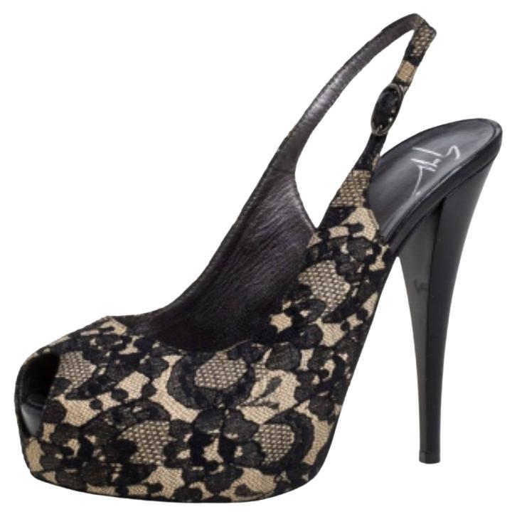 This pair of pumps by Giuseppe Zanotti will leave you looking like a diva. They are crafted from black lace and assembled with peep toes, slingbacks, and 14 cm heels supported by platforms. Add glamour to your closet by slipping into this gorgeous