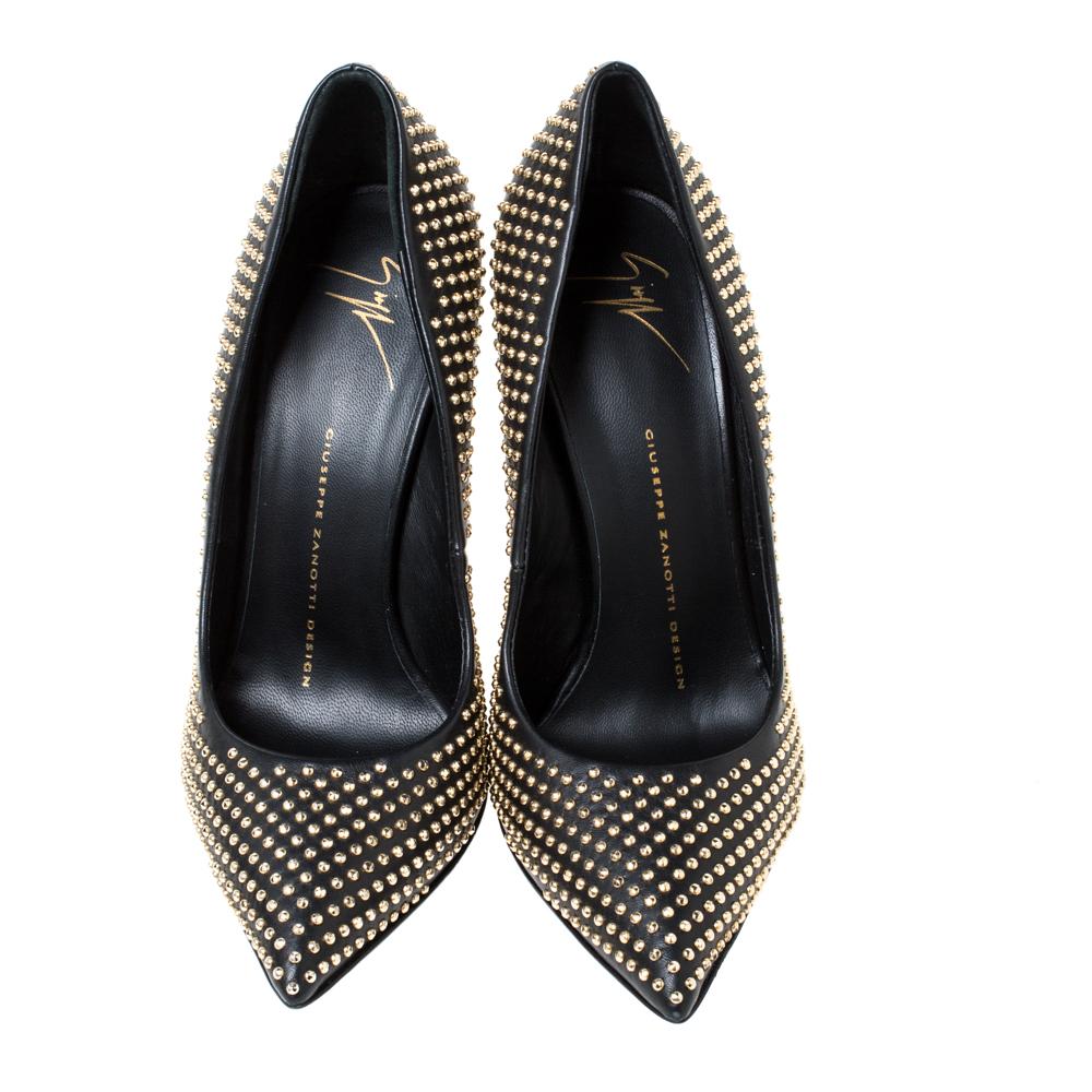 Revamp your footwear collection by adding this pair of shimmering Giuseppe Zanotti pumps to your wardrobe. The black pumps are crafted from leather & suede and feature exquisite stud embellishments adorning the exterior. Pointed toes, comfortable