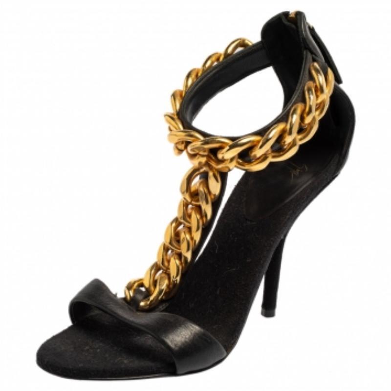 This classic pair of T-strap sandals are made exclusively for those special occasions. The bold black leather and the stunning gold-tone chain detail on the T-strap give it an impressive look. What's more? This is a Giuseppe Zanotti creation, a