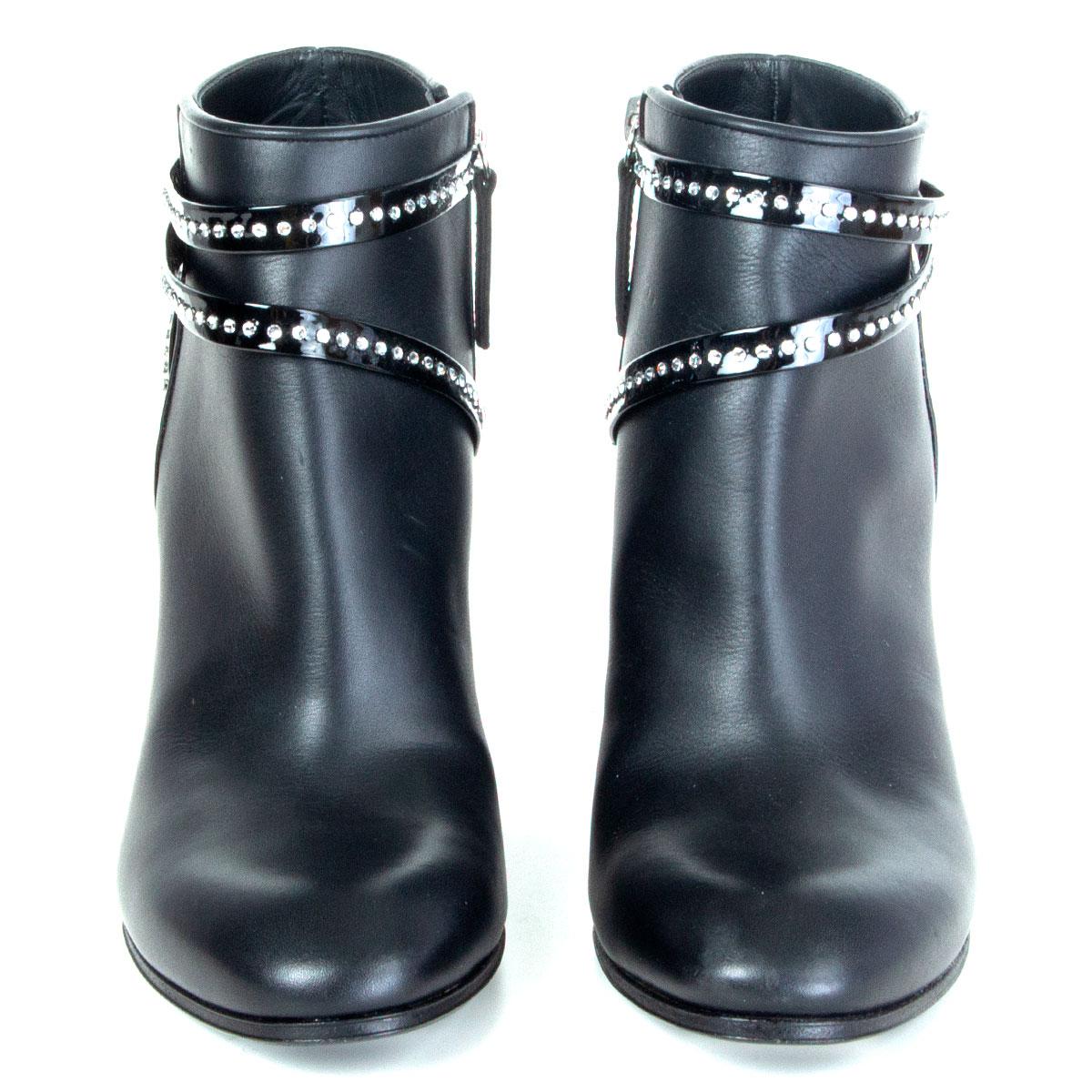 authentic Giuseppe Zanotti ankle-boots in black calfskin with rhinestone embellished patent leather straps around the ankle. Open with a zipper on the inside. Brand new. 

Imprinted Size 37
Shoe Size 37
Inside Sole 24.5cm (9.6in)
Width 7.5cm