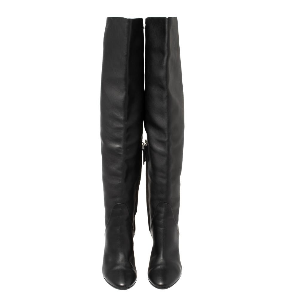 You can never go wrong with a classic pair of black boots. Crafted from genuine leather, the knee-length boots by Giuseppe Zanotti is an example of understated elegance. They have almond toes and silver-tone hardware details, land block heels ending