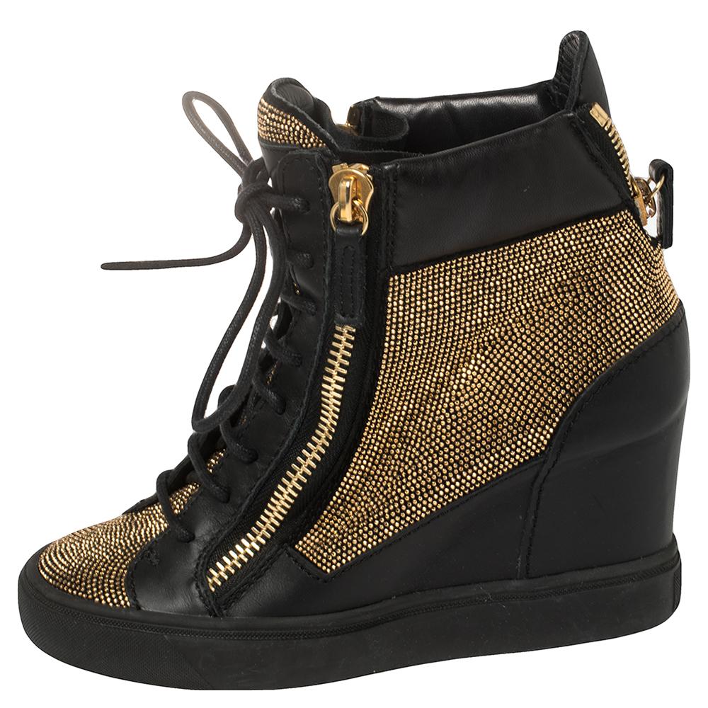 Highlighted with gold-tone zippers and gold-tone stud detailing on the front, Giuseppe Zanotti's wedge sneakers are meant to deliver a statement finish every time you put them on. They're fashioned using leather and set atop wedge heels.

