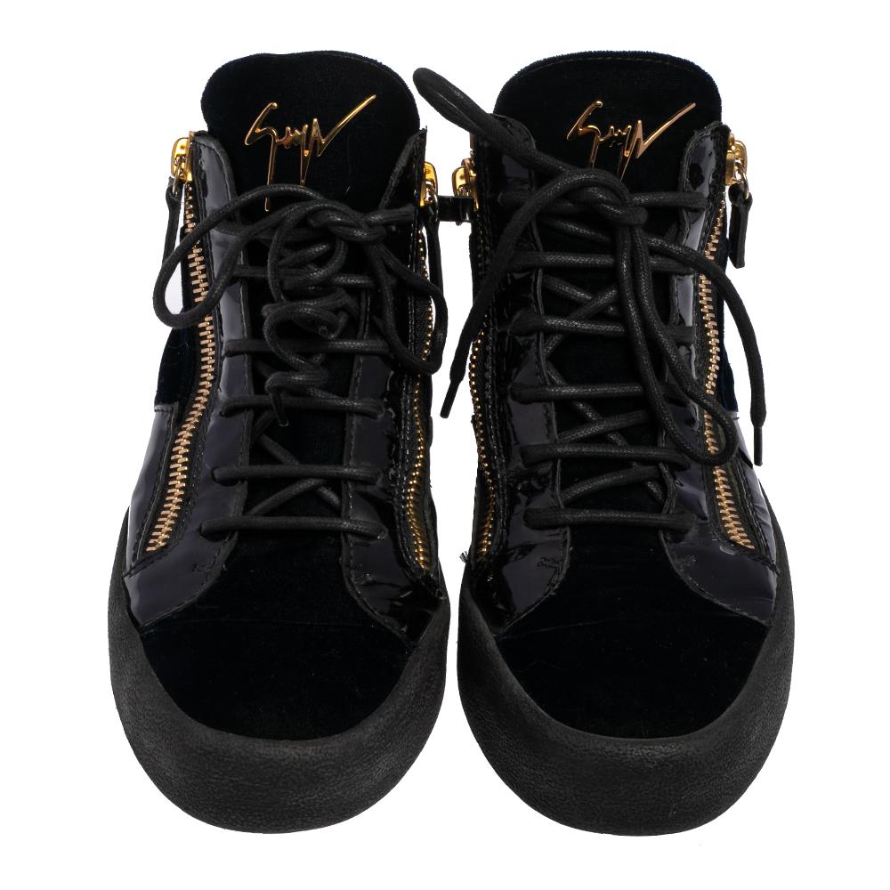 These Giuseppe Zanotti sneakers are stunning. Crafted in Italy, they are made of black leather, patent leather, and velvet. They come with lace-up fronts, brand detail on the tongue, double zip detailing, leather lining, and black rubber soles. They