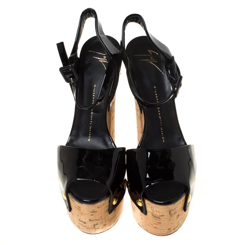 Step out in style with these Giuseppe Zanotti sandals. These flaunt a high cork heel; a raised platform; and a patent leather toe strap. It also features an adjustable ankle strap and extremely comfortable leather lining. Crafted in Spain, these are