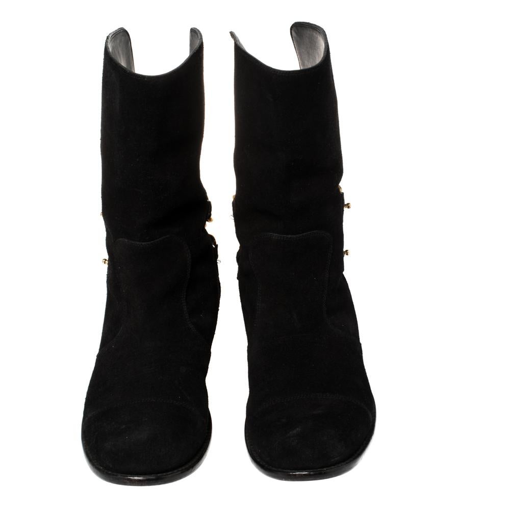 With a chic silhouette and gorgeous details, these ankle-length boots from Giuseppe Zanotti shine like no other! On a black suede construction, a round toe style emerges that is enhanced with gold-tone chain-links on the counters. Comfortable