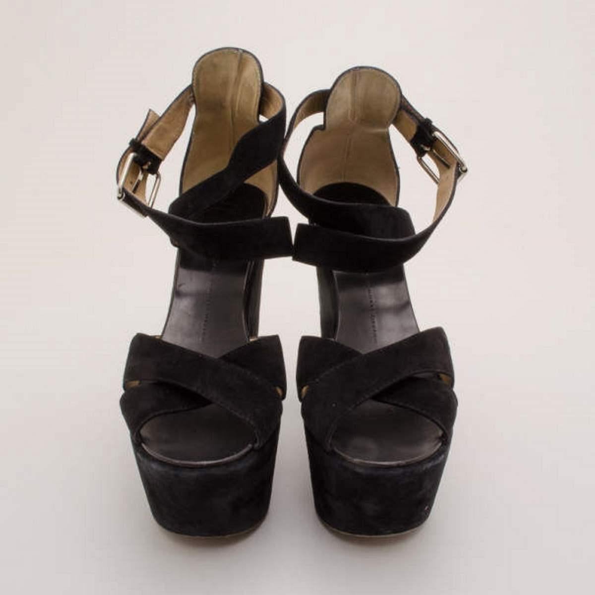 Receive plenty of attention when you rock these sky high suede platform sandals from Giuseppe Zanotti. These size 41 comfortable stacked platform sandals are made from black suede that feature strappy fronts and silver ankle closures. The interior