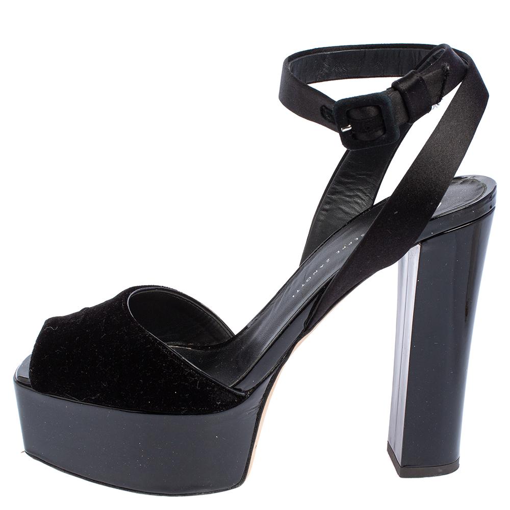 Giuseppe Zanotti's Lavinia sandals with bold platforms and block heels echo the philosophy of blending style with comfort. They are designed in black with velvet covering on the vamps and satin ankle straps secured with buckle closure. A versatile
