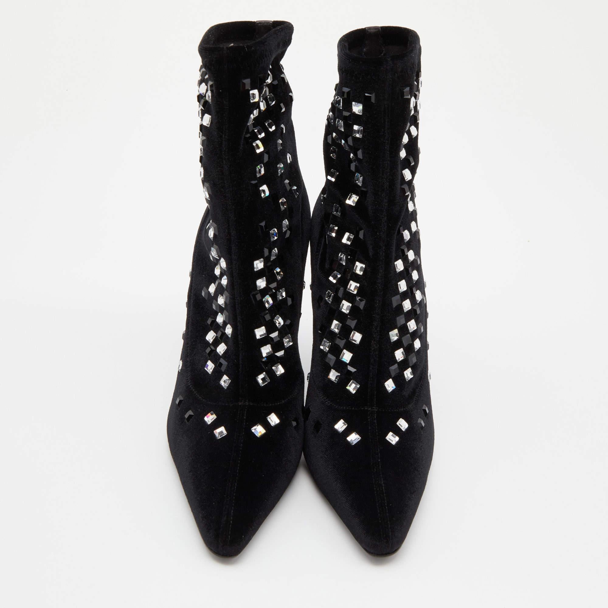 A pair of designer boots by Giuseppe Zanotti to light your steps in a fashionable manner. The black boots are finely crafted from velvet and designed with pointed toes, tall cm heels, and embellishments.

