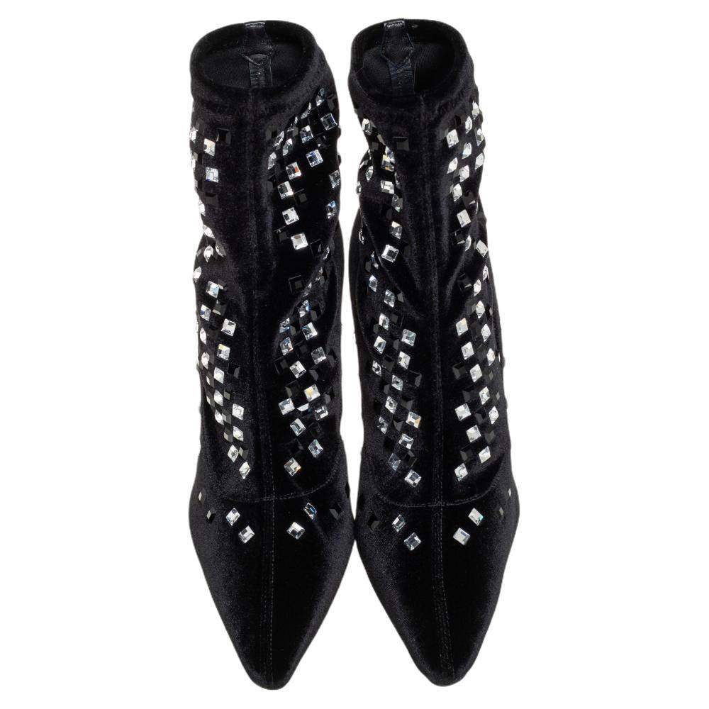 A pair of designer boots by Giuseppe Zanotti to light your steps in a fashionable manner. The black boots are finely crafted from velvet and designed with pointed toes, 10.5 cm heels, and embellishments.

