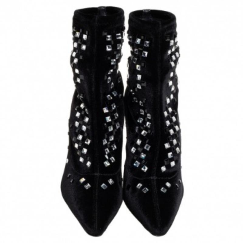 A pair of designer boots by Giuseppe Zanotti to light your steps in a fashionable manner. The black boots are finely crafted from velvet and designed with pointed toes, 9.5 cm heels, and embellishments.