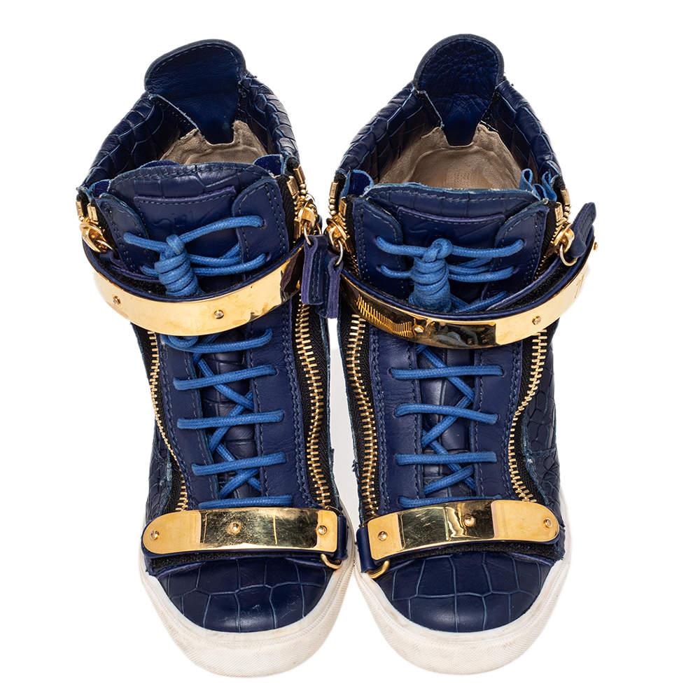 Bring home the luxurious high-fashion touch with these sneakers from Giuseppe Zanotti. Crafted from croc-embossed leather, these sneakers come flaunting suave details like the velcro straps, the lace-up, and the zipper details. You wouldn't want to