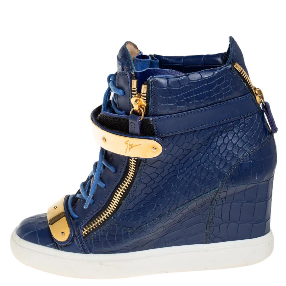 These sneakers by Giuseppe Zanotti are meant to be flaunted. Crafted from croc-embossed leather, they feature gorgeous gold-tone zipper details on the front and at the rear. The pair is beautifully completed with concealed wedges and gold-tone