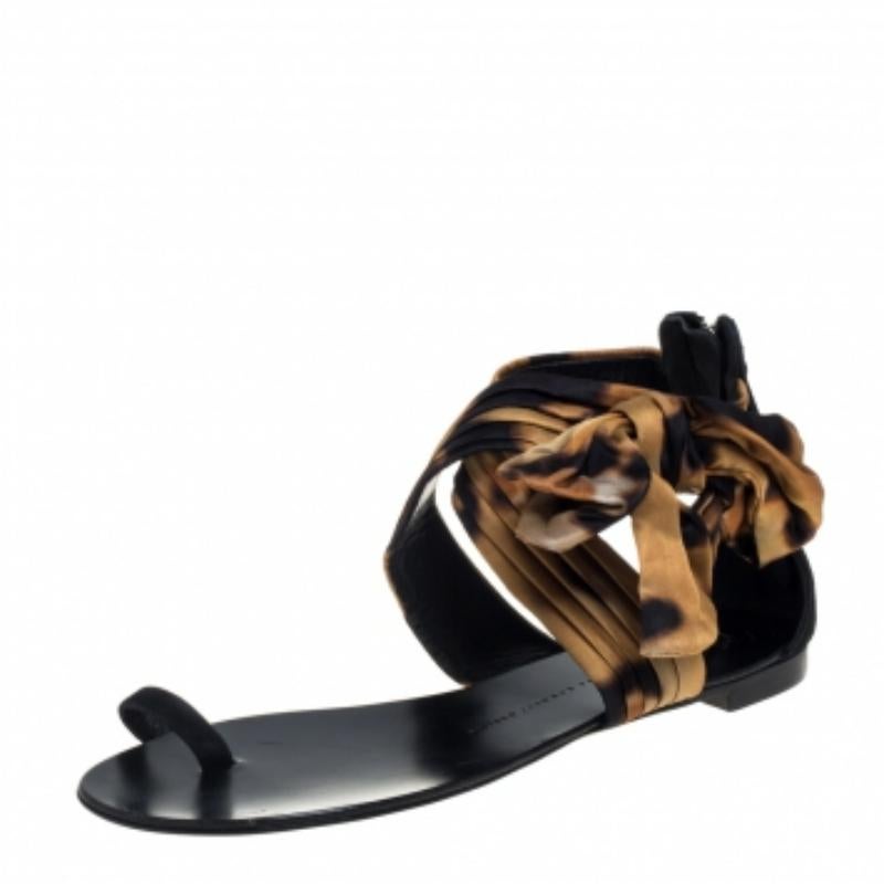 Incorporating luxe and contemporary elements, these sandals from Giuseppe Zanotti are simply amazing! They have been crafted from rich satin and styled with toe rings, pin-tucked cross ankle bow straps, and rear zippers. They are complete with
