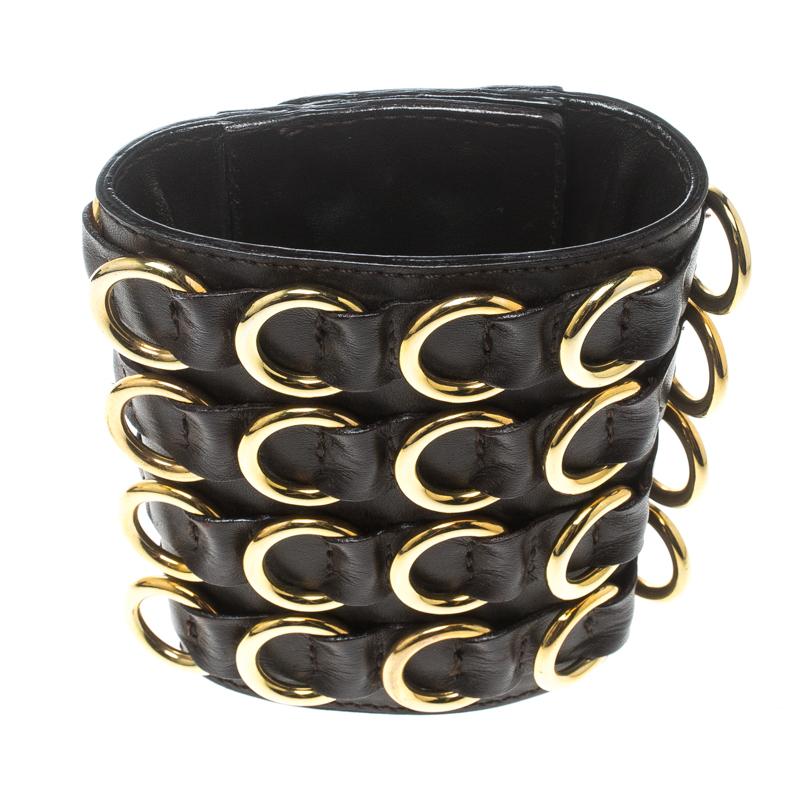This brown wide cuff bracelet from Giuseppe Zanotti will make sure that you receive praises wherever you go! It is crafted from leather and features multiple gold-tone metal accents that are creatively placed to form an interlocking pattern along