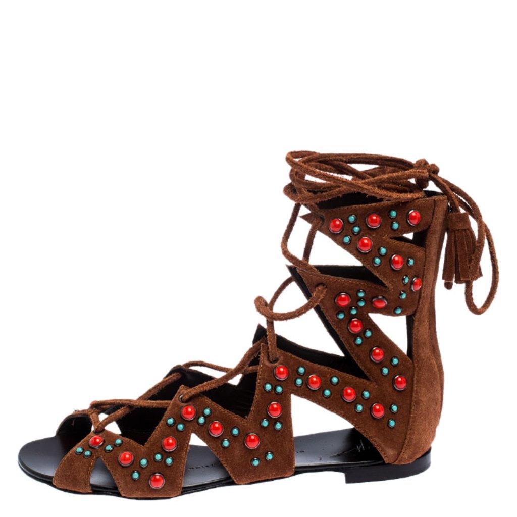 High on style, these flat sandals from Giuseppe Zanotti definitely need to be on your wishlist! The brown sandals are crafted from suede and feature an open toe silhouette. They flaunt a gladiator design with colourful studs all over. Leather