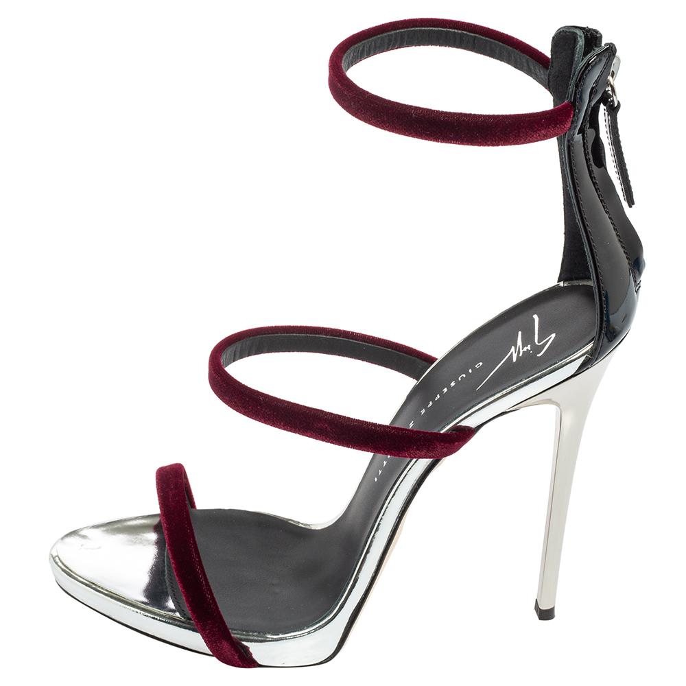 Merging elegant fashion and sensuous style, these burgundy-hued Giuseppe Zanotti Harmony sandals come crafted with patent leather and three velvet straps on each and fastened with zippers on the extended counters. They are visually stunning and they