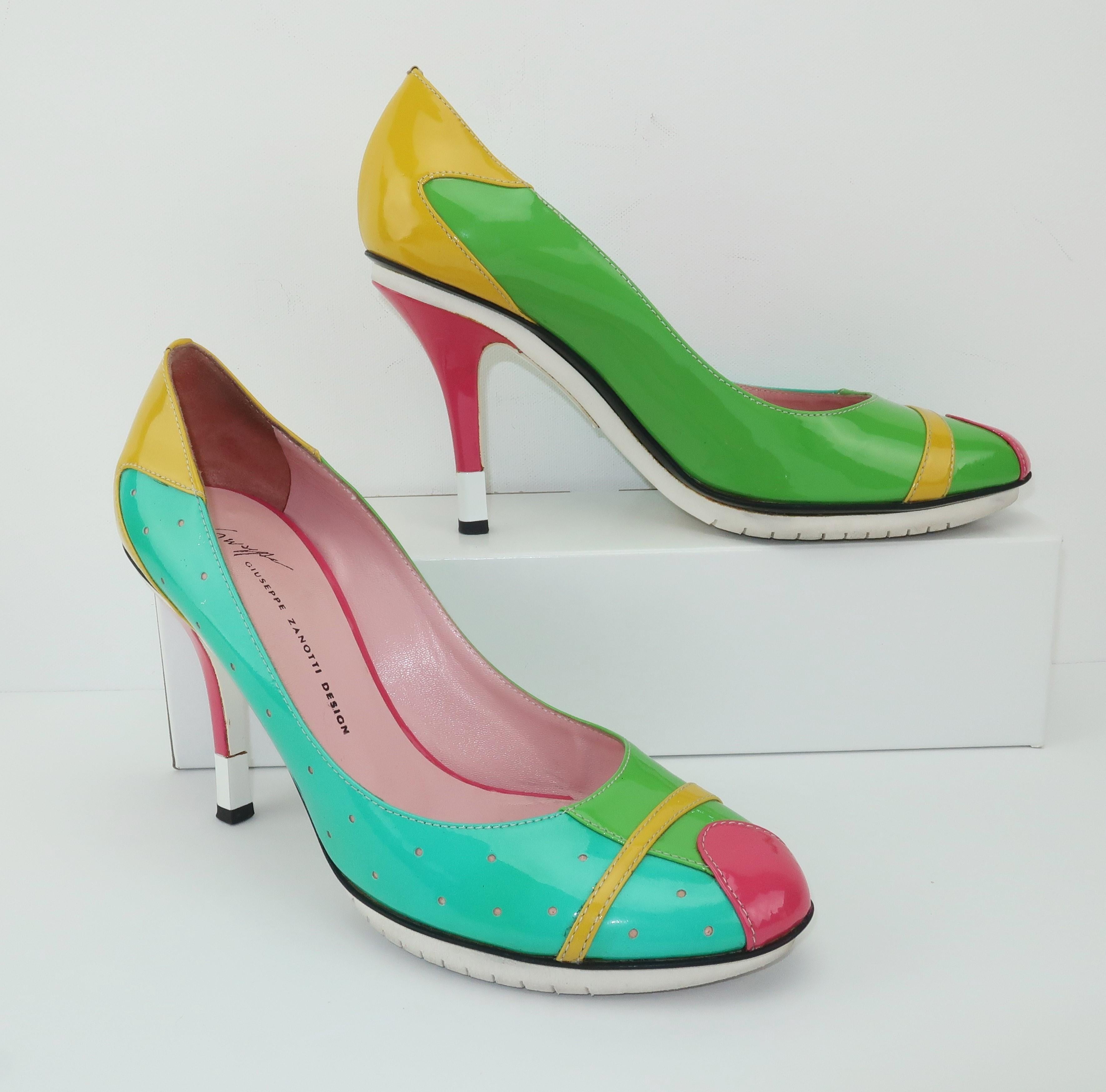 These Giuseppe Zanotti shoes are a colorful patchwork of bright patent leather with the silhouette of ladylike pumps and the details of sneakers.  The color block design includes shades of hot pink, green, turquoise and yellow with black piping and