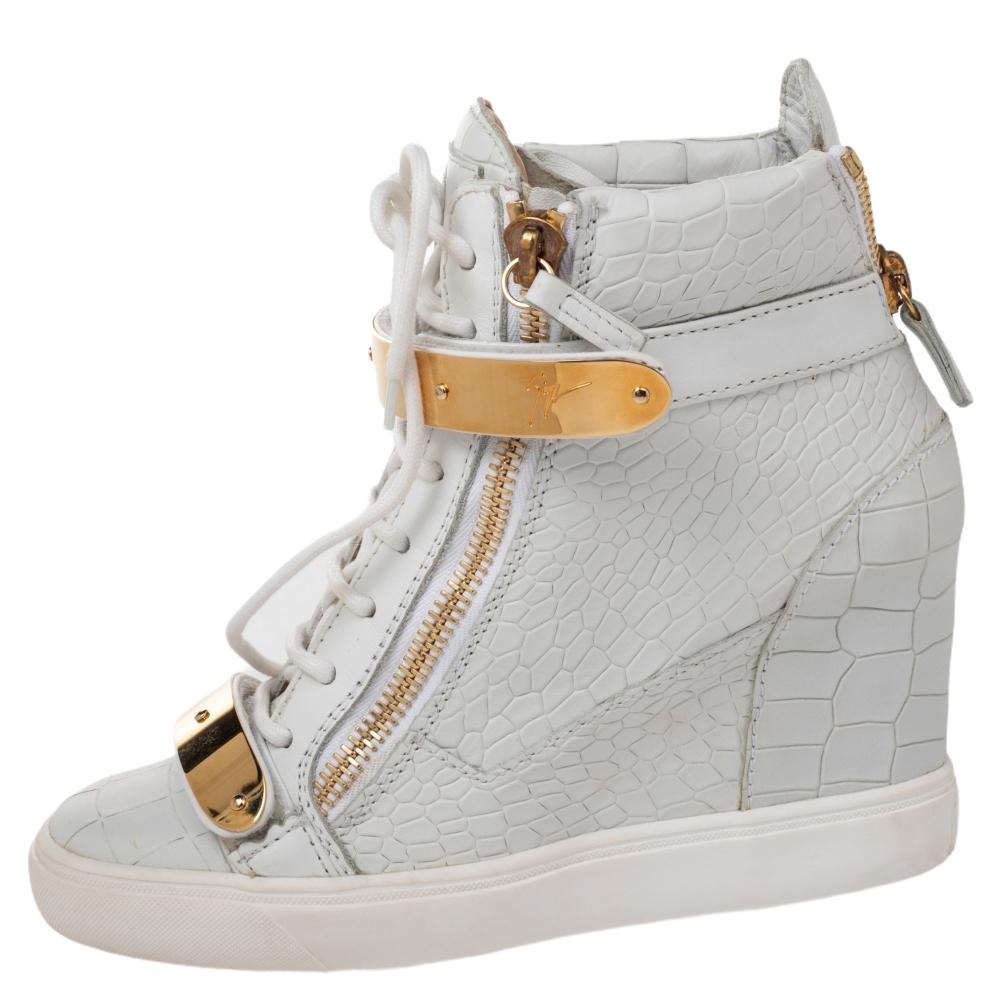 These sneakers by Giuseppe Zanotti are meant to be flaunted. Crafted from croc-embossed leather, they feature a gorgeous design of gold-tone zipper details on the front and at the rear. The pair is beautifully completed with concealed wedges and