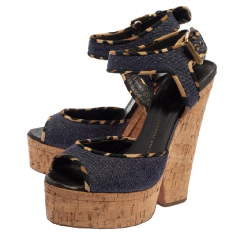 The perfect pair for summer, these stylish Giuseppe Zanotti sandals give out cool vibes. Their chunky 15.5 cm high cork heels are coupled with sturdy platforms. The blue denim exterior features adjustable buckled straps, open toes, and leather-lined