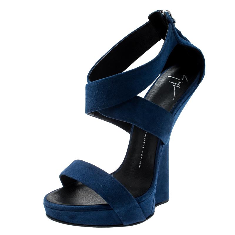 Walk in style and make the streets your fashion runway with these spectacular sandals from Giuseppe Zanotti. The blue sandals are meticulously crafted from soft suede and designed with open toes, crisscross ankle straps and comfortable insoles. To