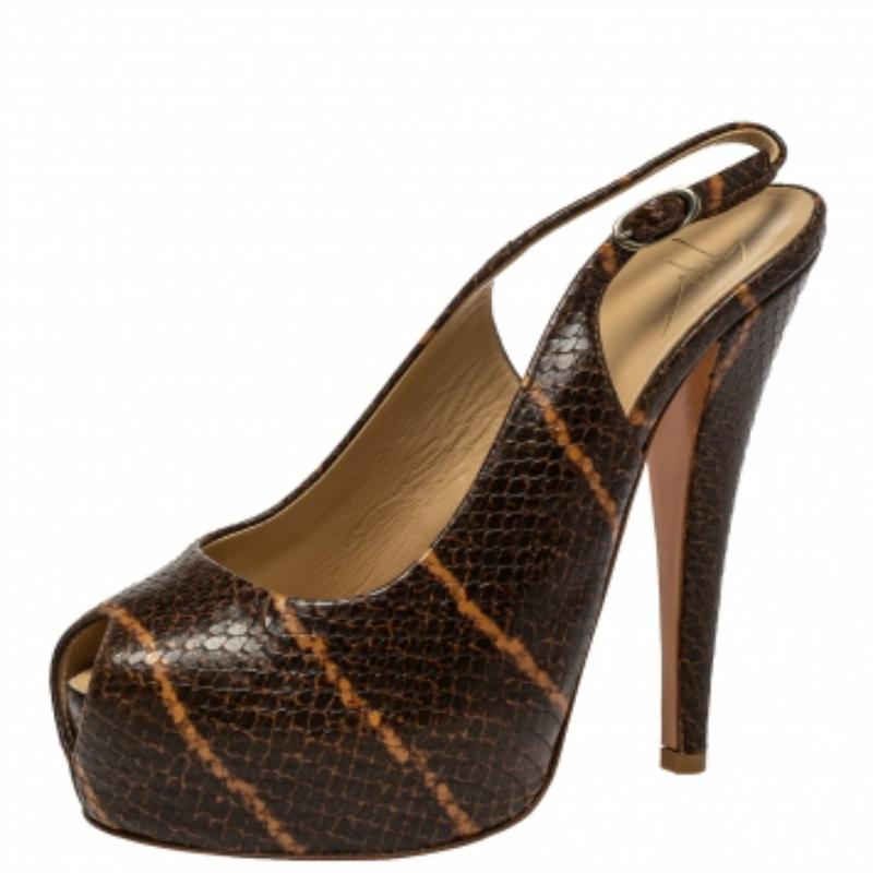 Be the show-stopper you are in these stunning sandals from the house of Giuseppe Zanotti. Designed in a brown python-embossed leather body, these sandals are set on sleek, towering heels supported by platforms. The peep-toe silhouette is finished
