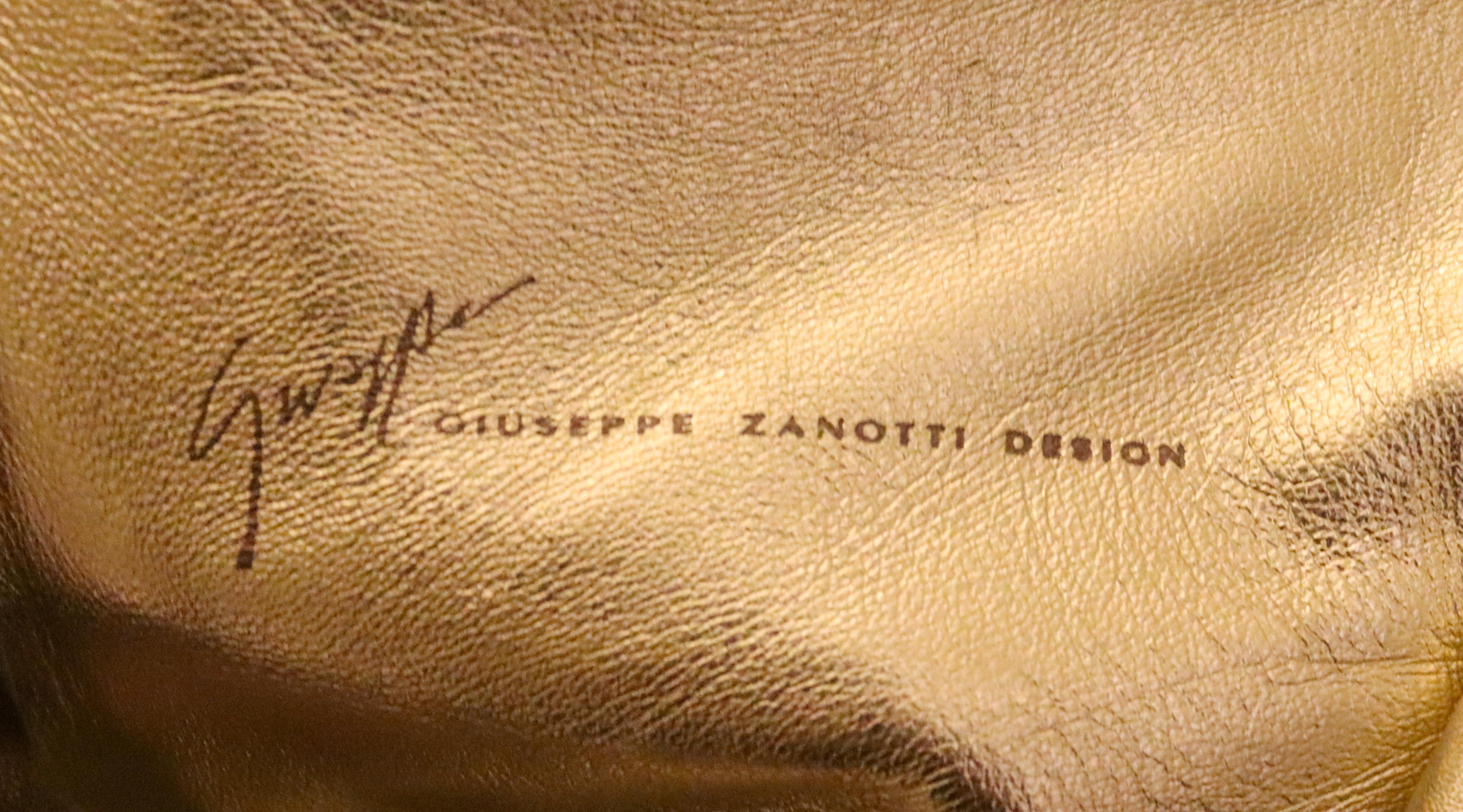 A festive pair of leather boots by Giuseppe Zanotti. 
The boots are made of super soft leather , with gold lining and bow detail. Made in Italy. Size 39
Heel height 3''