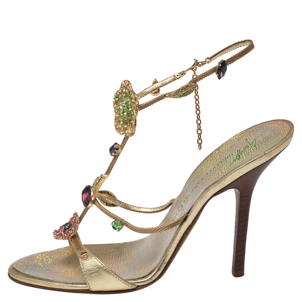 Giuseppe Zanotti yet again brings a stunning set of sandals that makes us marvel at its beauty and craftsmanship. Crafted from gold leather, they feature a caged design adorned with crystal embellishments that adds to the opulence of the silhouette.