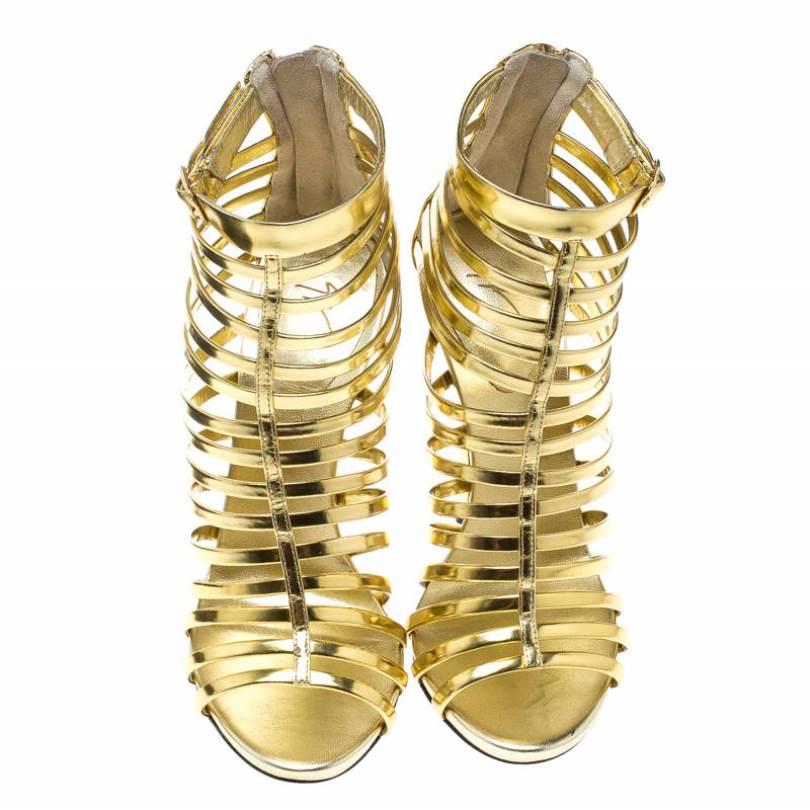 Trust Giuseppe Zanotti to give you edgy, and he serves it just perfectly. These gladiators are super-fashionable and well-made. Gold leather straps are laid in a caged design and back zippers are fitted on the counters. Leather insoles and slender