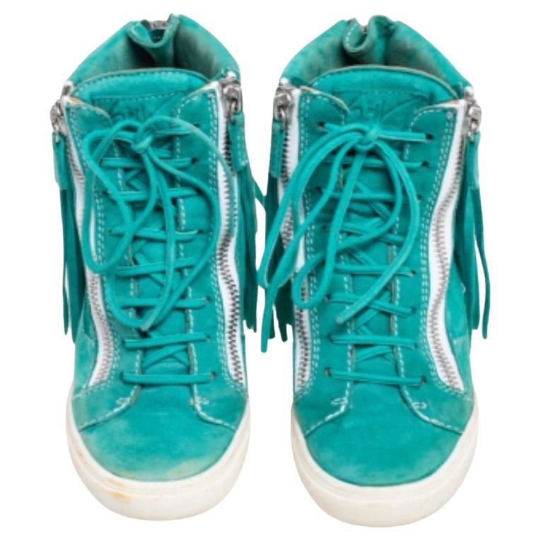 Comfort comes wrapped in these sneakers from Giuseppe Zanotti. They are crafted from suede and they bring details of lace-ups, fringes, and zippers. Elevated on wedge heels, these sneakers are easy to wear all day without compromising on style.