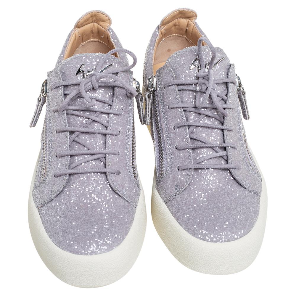 Coming from the house of Giuseppe Zanotti, these slip-on sneakers are both comfortable and stylish. They feature a dazzling glitter body and are set on thick rubber soles. Accented with side zip detailing and the label signature at the vamps, makes