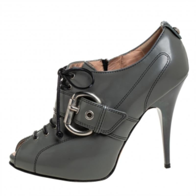 From the stunning collections of Giuseppe Zanotti, these splendid peep-toe booties are sure head-turners. Crafted in grey leather, they feature lace-up fronts with buckle strap details at the fronts and leather loop studs at the counters. Accented