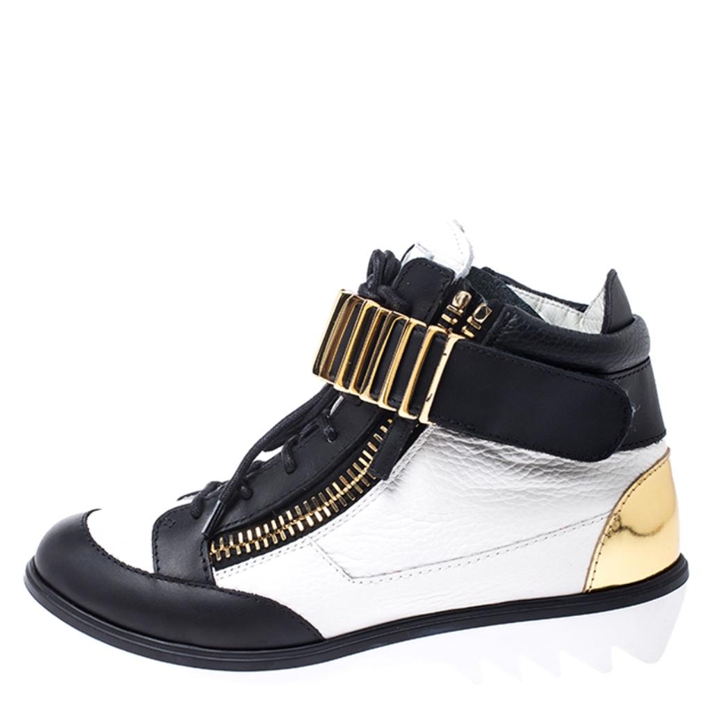 A statement in style and comfort, these shoes from Giuseppe Zanotti comes in a leather body. They are enhanced with a combination of black and white hues, lace-up front, an embellished strap across the ankles and zip accents at the quarters. The