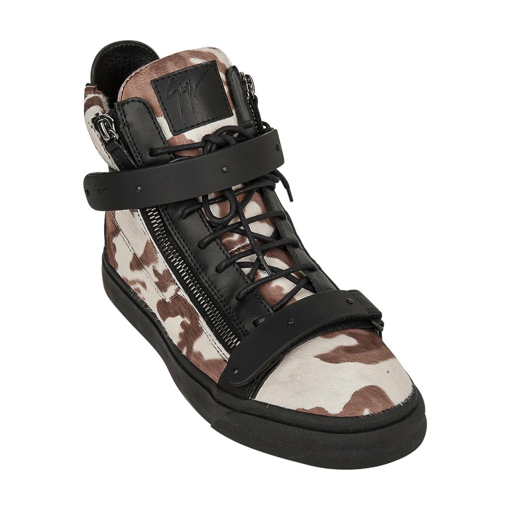 Guaranteed authentic Giuseppe Zanotti mens high top sneakers features camo pony and black leather. 
Brown and bone with leather logo plaque on tongue.
Velcro across ankle grip.
Zip detail along sides and rear of shoe. 
Comes with signature box. 
NEW