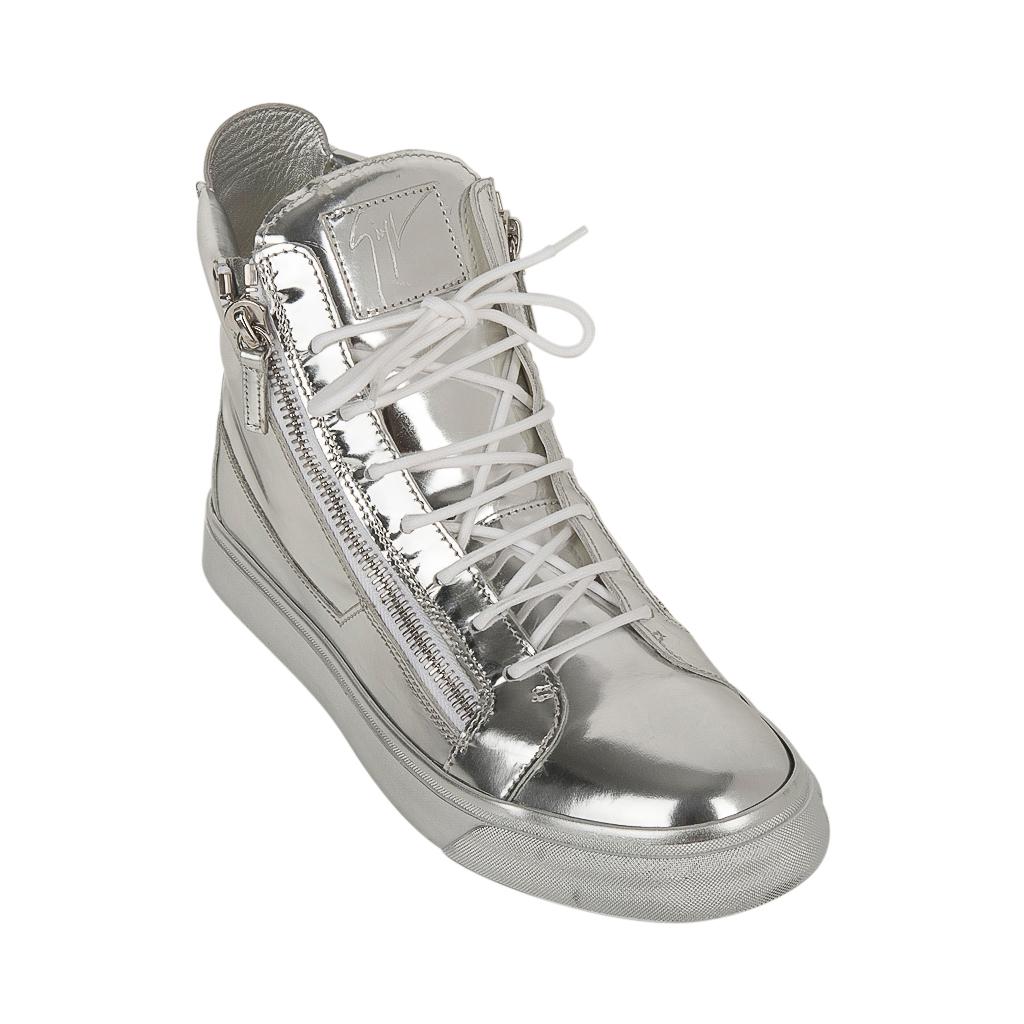 Guaranteed authentic Giuseppe Zanotti men's silver high top sneaker. 
Bold and fabulous with silver logo plaque on tongue.
Zip detail along sides and rear of shoe. 
Comes with signature box.
Does have light hairline markings.  See images.
NEW or