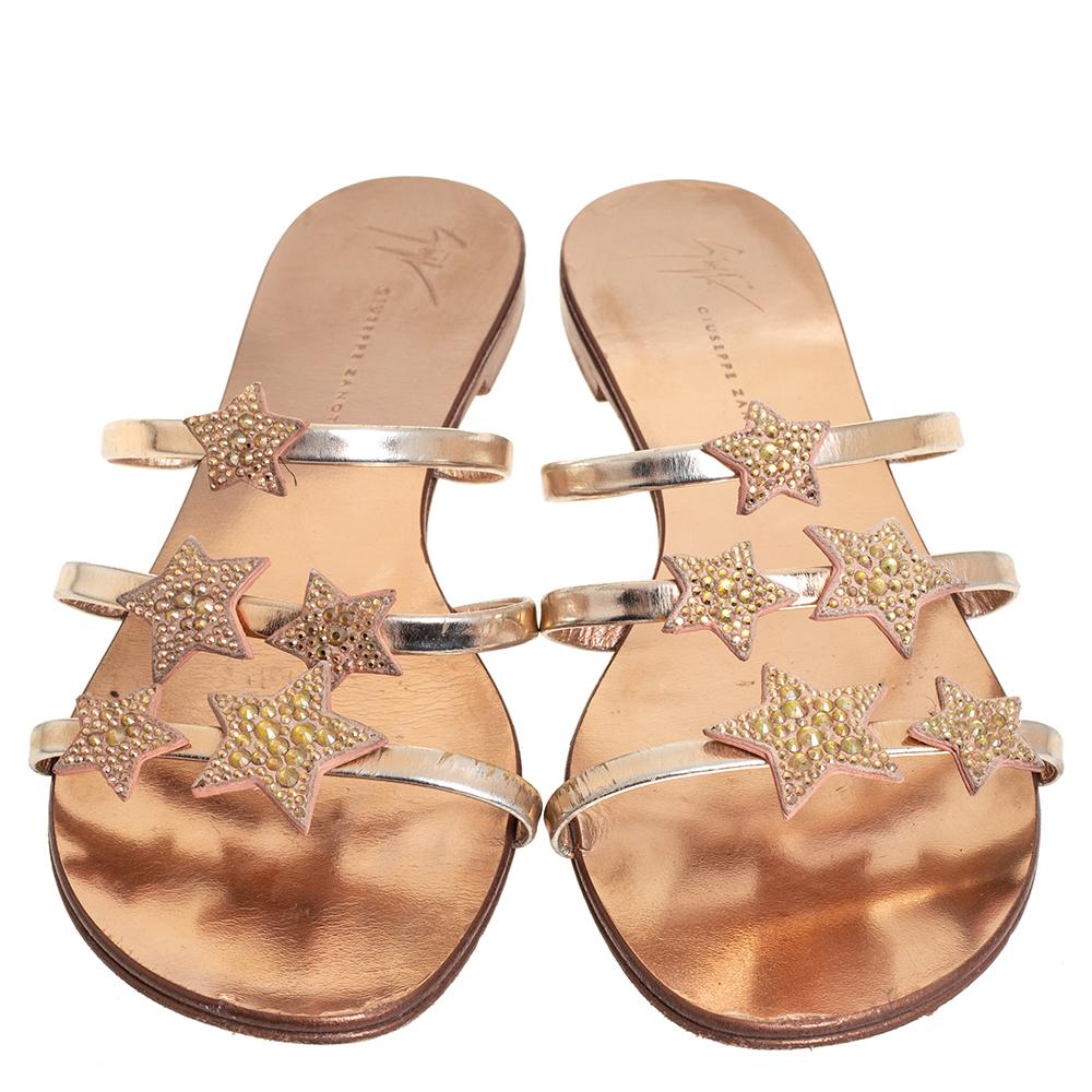 It is rare when glamour and comfort come together but thanks to Giuseppe Zanotti for making it happen with these stunning slide flats. Crafted from leather in a metallic bronze shade, they are adorned with crystal embellished star motifs on the