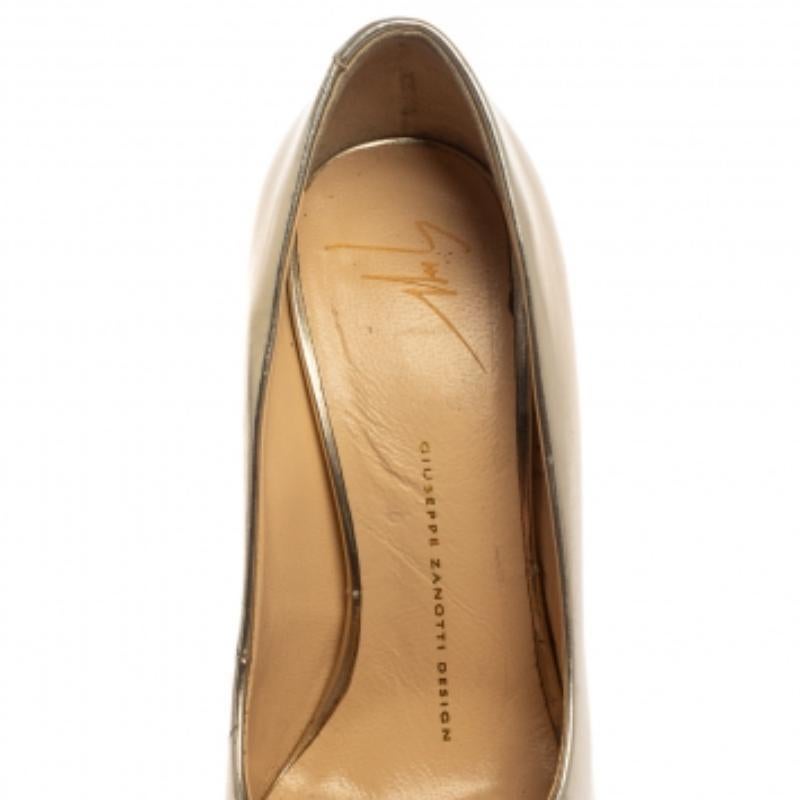 Transform into a style diva when you wear these glamorous Giuseppe Zanotti pumps. They are crafted from metallic gold leather and styled with peep toes. They flaunt well-cut vamps and come equipped with comfortable leather-lined insoles, solid