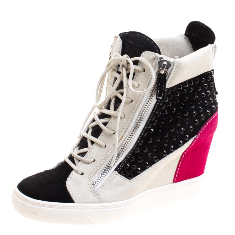 Your outfit demands a pair of sneakers but you just cannot compromise on your high heels? The solution is right here for you in Giuseppe Zanotti Multicolor Studded Suede Lamay High Top Sneakers. The silver toned suede body with a bright heel is the