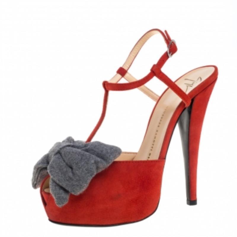 These luxurious and stylish sandals by Giuseppe Zanotti are sure to complement your outfits beautifully. Crafted from orange suede, they feature self-covered platforms with peep toes and bow details on the vamps. These sandals come with wrap-around