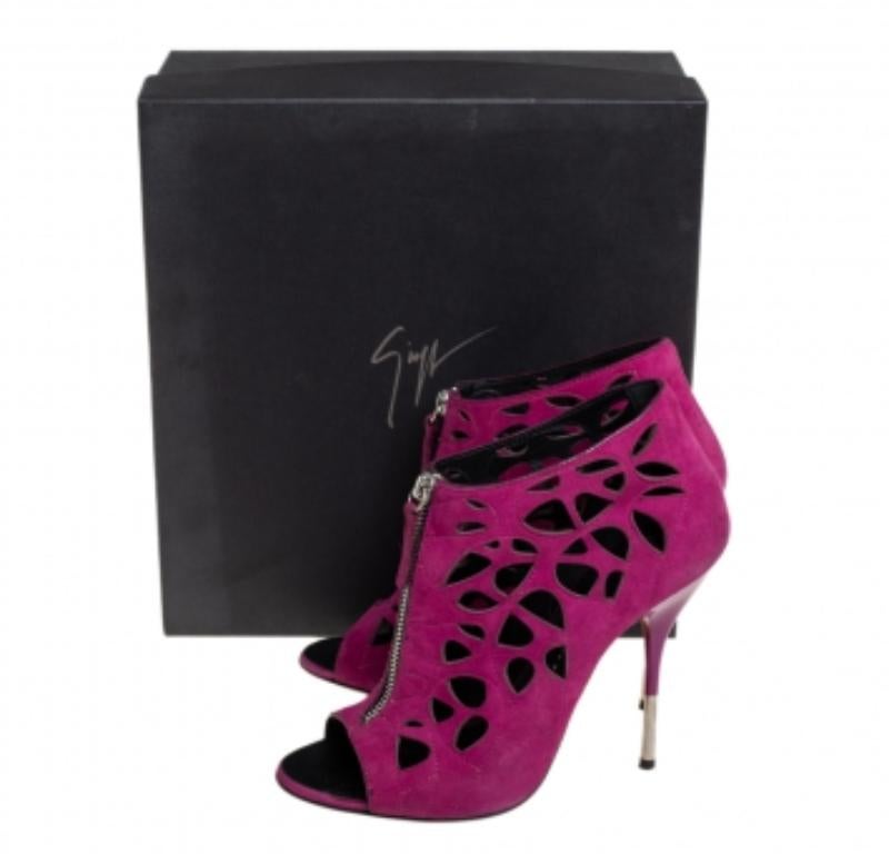 These pink suede zipper booties from Giuseppe Zanotti feature an open toe, cut-out details, a high stiletto heel, a back zip fastening, and a branded insole. They are ideal to lend a dramatic twist to a basic outfit. Flaunt these pink booties with a