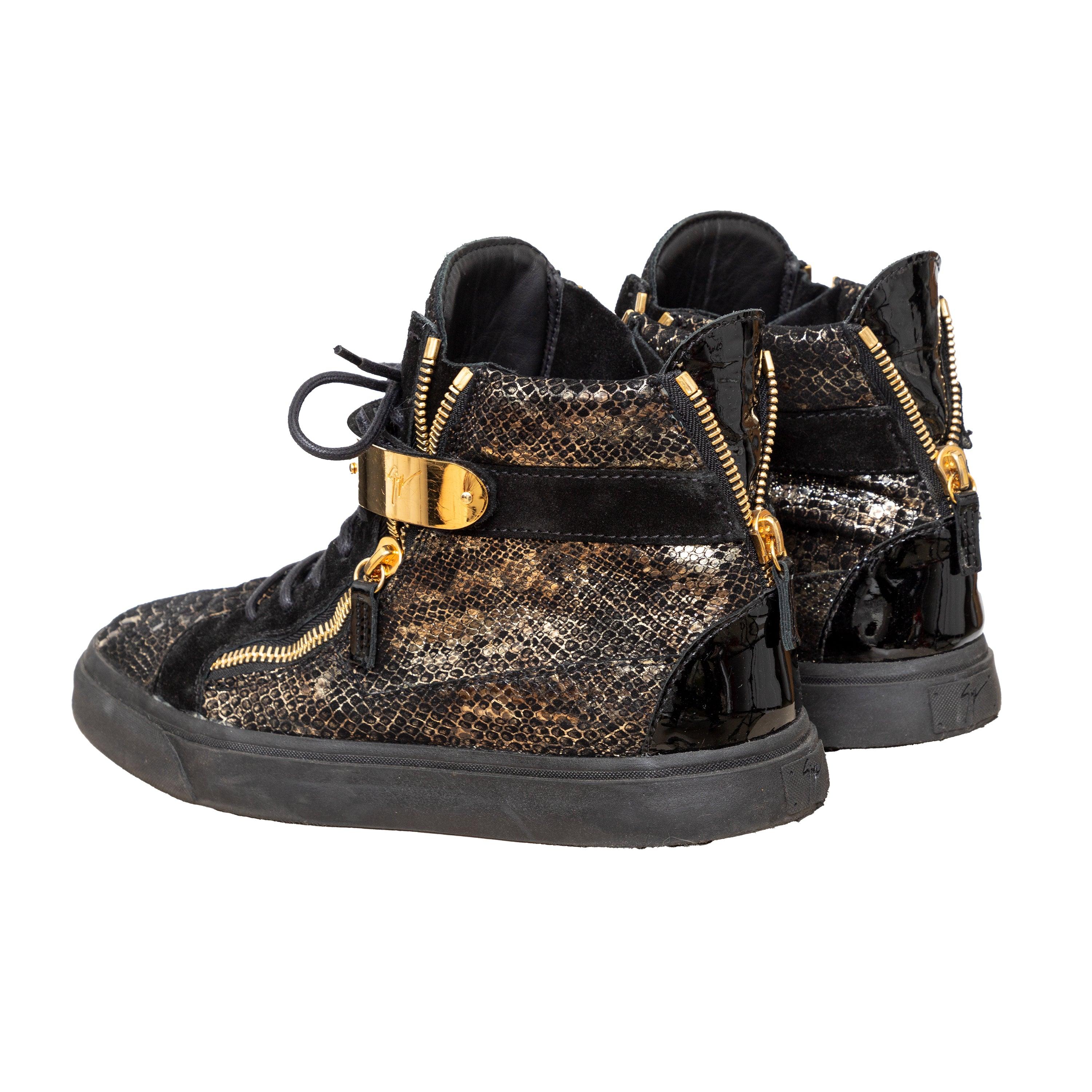 Elevate your sneaker game with Giuseppe Zanotti's Printed Snakeskin Sneakers. The high-top design features a unique snakeskin print on the signature Coby model, with a velvet and leather construction. Complete with a double gold metal strap and