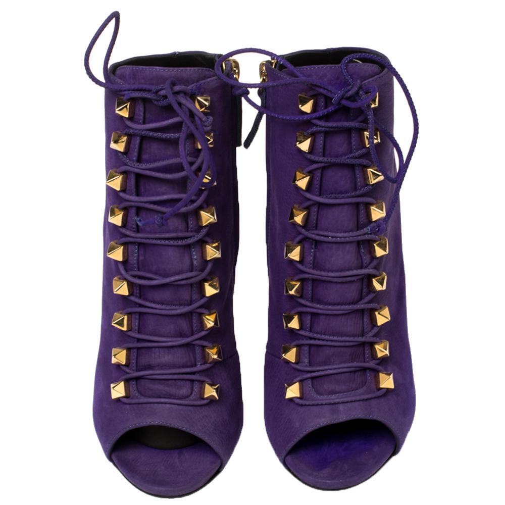 These glamorous boots from Giuseppe Zanotti are chic and worth admiring! They have been crafted from purple suede and styled with peep-toes and gold-tone pyramid studded lace-ups on the vamps. They flaunt side zippers and come equipped with
