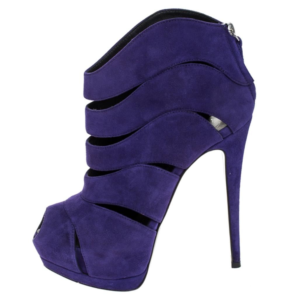 This pair of booties by Giuseppe Zanotti will make heads turn your way wherever you go. Crafted in Italy, they are made from quality suede and come in a lovely shade of purple. They feature peep toes, cut out detailing, zip closures, 4 cm platforms,