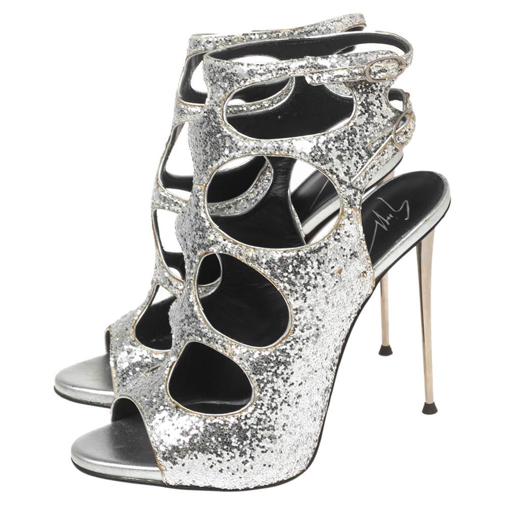 Bring back the disco days with these glittery sandals by Giuseppe Zanotti. Part of the A/W 14/15 collection, these sandals have a caged cutout design with ankle buckle fastenings. Standing at 11.5 cm, these sandals are lined with leather and have