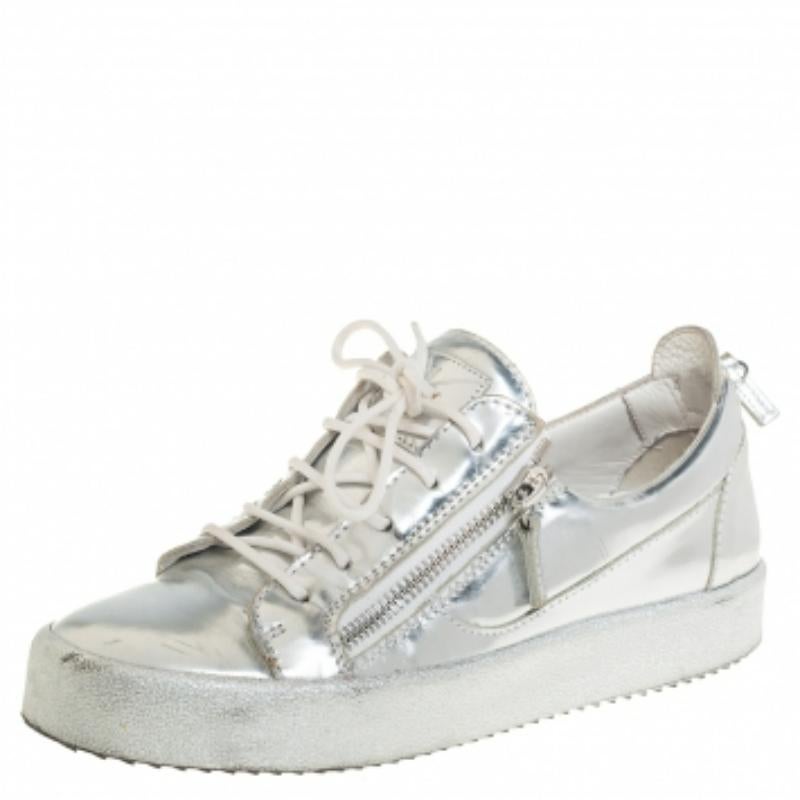 These stylish Giuseppe Zanotti sneakers are meant to deliver signature looks every time. Crafted from silver leather, they feature round toes, lace-ups on the vamps, and zipper details on the sides and the counters. They are complete with