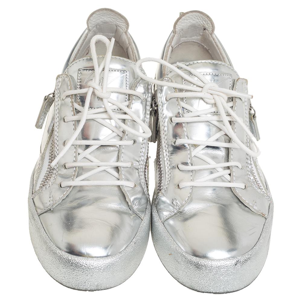 These stylish Giuseppe Zanotti sneakers are meant to deliver signature looks every time. Crafted from silver leather, they feature round toes, lace-ups on the vamps, and zipper details on the sides and the counters. They are complete with